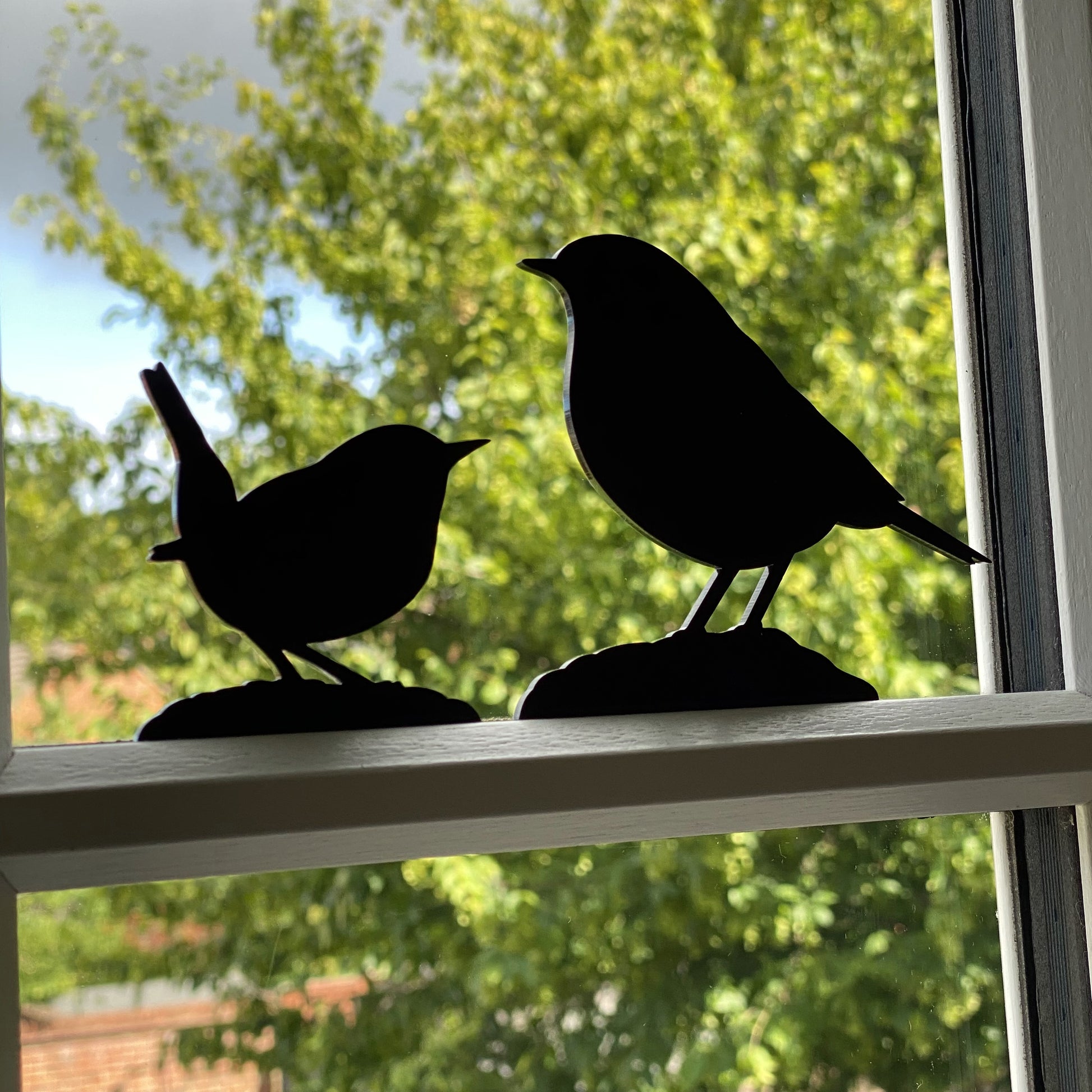 Minimalist bird sculptures in matt black, designed for indoor and outdoor use including robin, wren, and more