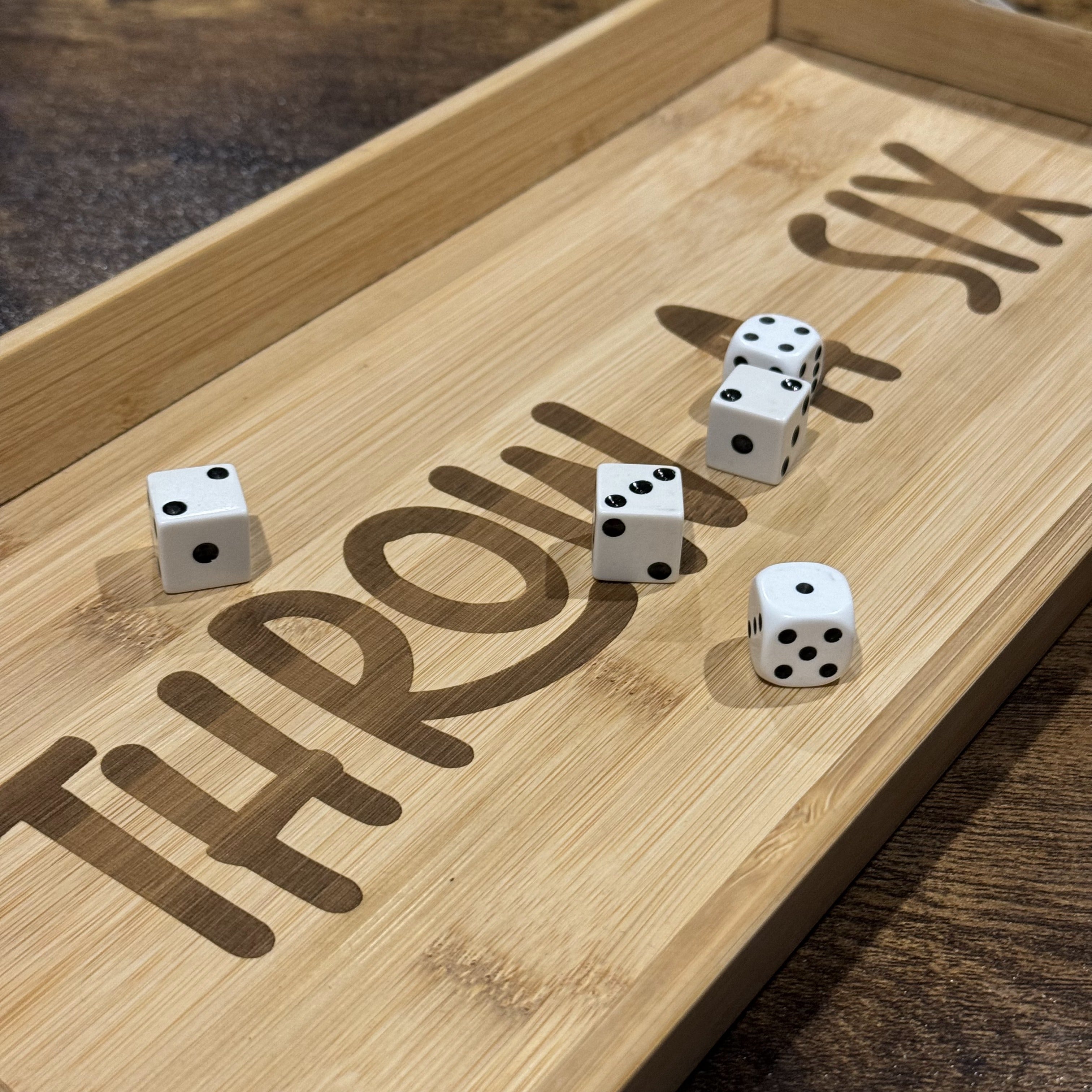 Wooden dice tray engraved with ‘Throw a Six’ in funky font, featuring high-quality laser engraving