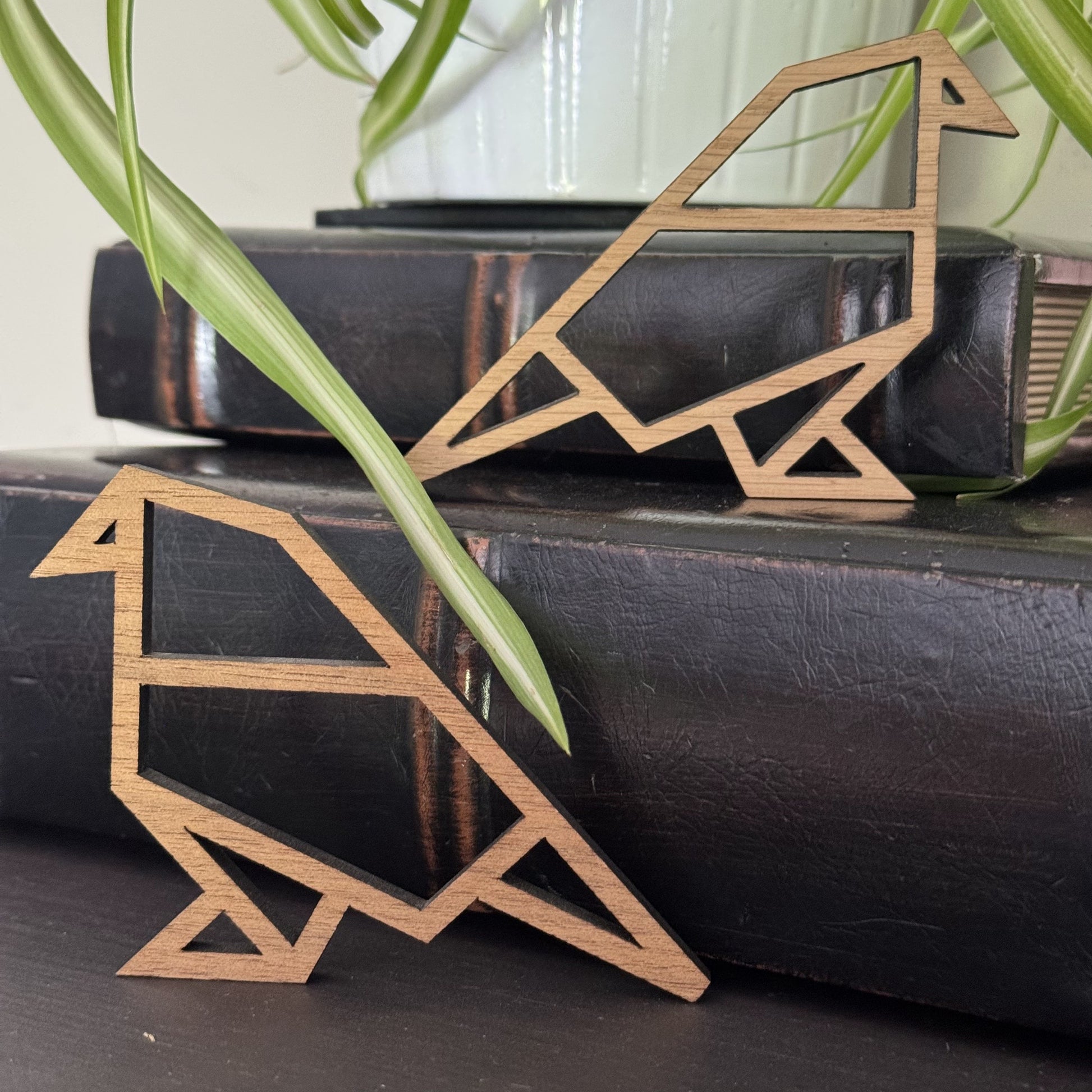 Walnut and oak origami birds perched on books – warm, nature-inspired wooden shelf decor