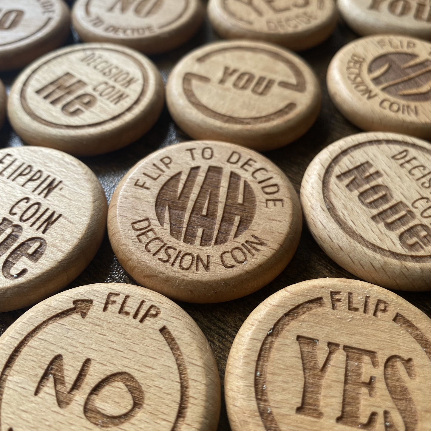  A close up of the Ultimate Decision Maker Coins with all design options laid out, highlighting the quality and engravings.