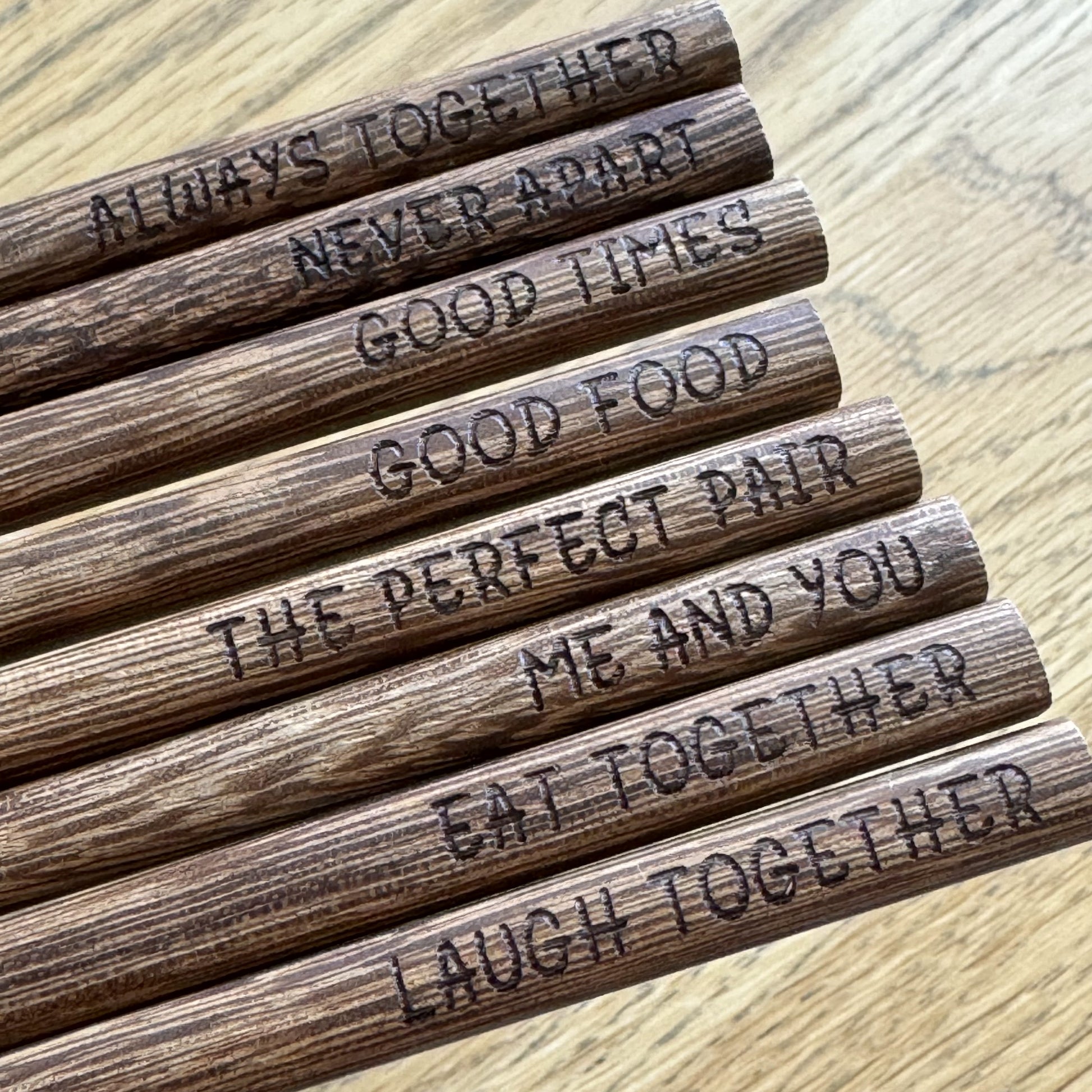 Detailed close-up of engraved wenge chopsticks.