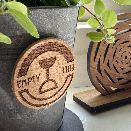'The Wine Dial' Empty Full spinner displayed on a plant pot – decorative and fun gift accessory